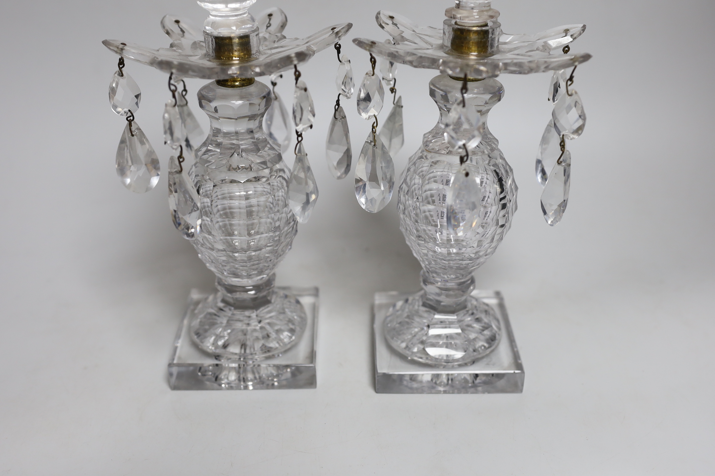 A pair of early 19th century cut glass table lustres, on faceted square bases, 26cm